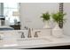 Bathroom with a white quartz countertop, bronze faucet and greenery at 1981 Central Park Rd, Charleston, SC 29412