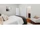 Bright bedroom with hardwood floors leading to an open bathroom doorway at 1981 Central Park Rd, Charleston, SC 29412