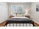 Charming bedroom with a metal bed, hardwood floors, and bright natural light from the window at 1981 Central Park Rd, Charleston, SC 29412