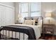 Inviting bedroom featuring a black bed frame, hardwood floors, and a bright window at 1981 Central Park Rd, Charleston, SC 29412