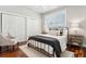 Cozy bedroom featuring wood floors, a black metal bed frame, and bright natural light at 1981 Central Park Rd, Charleston, SC 29412