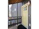 Stylish yellow front door and black metal railing on a modern home's elevated porch at 1981 Central Park Rd, Charleston, SC 29412