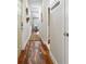 Hallway with beautiful wood flooring and a view into the living room at 1981 Central Park Rd, Charleston, SC 29412