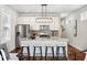 Open-concept kitchen with barstool seating at the island, stainless steel appliances, and modern lighting at 1981 Central Park Rd, Charleston, SC 29412