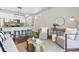 Open-concept living room featuring stylish furniture, modern decor, and an eat-in kitchen at 1981 Central Park Rd, Charleston, SC 29412
