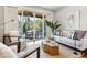 Sunlit living room flows to covered balcony, creating a seamless indoor-outdoor living experience at 1981 Central Park Rd, Charleston, SC 29412