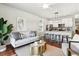 Open-concept living room featuring stylish furniture, modern decor, and an eat-in kitchen with bar seating at 1981 Central Park Rd, Charleston, SC 29412