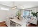 Open floor plan with kitchen island, stainless steel appliances and a bright living room at 1981 Central Park Rd, Charleston, SC 29412