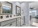 Bathroom featuring a double sink vanity, framed mirrors, and access to the shower at 201 Garden Lily Lane, Summerville, SC 29485