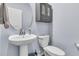 Charming powder room with pedestal sink, round mirror, and stylish fixtures at 201 Garden Lily Lane, Summerville, SC 29485