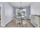 Bright dining room with wood-look floors, light blue walls, and stylish furnishings at 201 Garden Lily Lane, Summerville, SC 29485