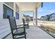 Cozy covered porch with rocking chairs offers a relaxing outdoor space with neighborhood views at 201 Garden Lily Lane, Summerville, SC 29485