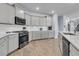 Well-equipped kitchen with stainless steel appliances, stylish backsplash, and ample cabinet space at 201 Garden Lily Lane, Summerville, SC 29485