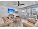 Cozy living room featuring a large TV, neutral furniture, and plenty of natural light at 201 Garden Lily Lane, Summerville, SC 29485