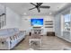 Inviting living room featuring a large TV, neutral furniture, and a stylish ceiling fan at 201 Garden Lily Lane, Summerville, SC 29485