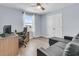 Office space with a desk, office chair, and black sofa with natural light streaming through the window at 201 Garden Lily Lane, Summerville, SC 29485