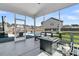 Covered back porch features a fire pit, outdoor furniture, and a view of the pool at 201 Garden Lily Lane, Summerville, SC 29485