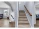Carpeted staircase leading to the upper level with light-blue walls and a wooden handrail at 201 Garden Lily Lane, Summerville, SC 29485