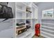 Bright walk-in closet with custom shelves, ample storage, and a window for natural light at 201 Garden Lily Lane, Summerville, SC 29485