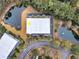 Aerial view of a well-maintained property with lush greenery, ponds, and mature trees nestled in a peaceful community at 2032 Amenity Park Dr, Mount Pleasant, SC 29466