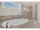 Luxurious bathroom with soaking tub, glass-enclosed shower, and natural light from a window at 2032 Amenity Park Dr, Mount Pleasant, SC 29466