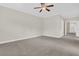 Spacious bedroom with neutral carpeting, crown molding, and multiple entryways at 2032 Amenity Park Dr, Mount Pleasant, SC 29466
