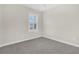 Comfortable bedroom with neutral walls, soft carpet, and a bright window creating a serene space with a touch of simplicity at 2032 Amenity Park Dr, Mount Pleasant, SC 29466