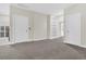 Bright bonus room featuring neutral walls, soft gray carpet, and built-in shelving for versatile living and storage options at 2032 Amenity Park Dr, Mount Pleasant, SC 29466