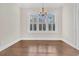 Empty dining room featuring hardwood floors, white trim and multiple windows with white shutters at 2032 Amenity Park Dr, Mount Pleasant, SC 29466