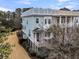 Charming multi-story townhome with colorful accents, manicured landscaping, and a welcoming front porch at 2032 Amenity Park Dr, Mount Pleasant, SC 29466