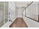 Inviting foyer with hardwood floors, decorative glass door, staircase with white railings, and natural light at 2032 Amenity Park Dr, Mount Pleasant, SC 29466
