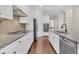 Spacious kitchen features white cabinets, granite counters, stainless appliances, and hardwood floors at 2032 Amenity Park Dr, Mount Pleasant, SC 29466