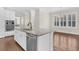 Charming kitchen features a center island with stainless steel dishwasher and faucet, and hardwood flooring at 2032 Amenity Park Dr, Mount Pleasant, SC 29466