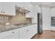 Bright kitchen featuring stainless appliances, granite countertops, white cabinets and tile backsplash at 2032 Amenity Park Dr, Mount Pleasant, SC 29466