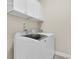 Efficient laundry room with overhead storage, modern washer and dryer providing functionality and convenience at 2032 Amenity Park Dr, Mount Pleasant, SC 29466
