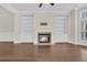 Spacious living room featuring a fireplace, hardwood floors, and custom built-in shelving at 2032 Amenity Park Dr, Mount Pleasant, SC 29466