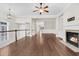 Bright living room with hardwood floors, fireplace, ceiling fan, and access to the staircase at 2032 Amenity Park Dr, Mount Pleasant, SC 29466