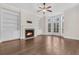 Cozy living room featuring a fireplace, built-in shelving, hardwood floors, and a bay window at 2032 Amenity Park Dr, Mount Pleasant, SC 29466