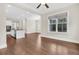 Open-concept living space with hardwood floors, white trim, and a view of the kitchen and dining area at 2032 Amenity Park Dr, Mount Pleasant, SC 29466