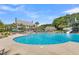 Large swimming pool with lots of seating and umbrellas, adjacent to a clubhouse with a waterslide at 2032 Amenity Park Dr, Mount Pleasant, SC 29466