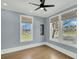 Inviting bedroom featuring three large windows, neutral paint, and modern ceiling fan at 2097 Mt Pleasant St, Charleston, SC 29403