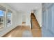 Bright entryway with gleaming hardwood floors, stairs, and neutral paint colors at 2097 Mt Pleasant St, Charleston, SC 29403