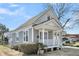 Charming grey home with white trim, a welcoming front porch, and well-maintained landscaping at 2097 Mt Pleasant St, Charleston, SC 29403