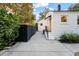 Backyard concrete patio with modern privacy fence, exterior entrance, and well-kept landscaping add privacy and appeal at 2115 Wappoo Dr, Charleston, SC 29412