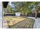 Large backyard with mature trees, privacy fence, storage shed and decorative gravel path at 2115 Wappoo Dr, Charleston, SC 29412