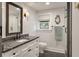 Well-lit bathroom with black fixtures, a granite countertop, hexagon tile floor, and glass-enclosed shower at 2115 Wappoo Dr, Charleston, SC 29412