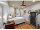 Cozy bedroom with hardwood floors, a ceiling fan, a comfy bed, and a treadmill at 2115 Wappoo Dr, Charleston, SC 29412