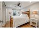 Comfortable bedroom featuring hardwood floors, a wooden bed frame, white bedding, a ceiling fan, and natural light at 2115 Wappoo Dr, Charleston, SC 29412