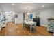 Open dining room with hardwood floors, chandelier, and access to the kitchen and hallway at 2115 Wappoo Dr, Charleston, SC 29412