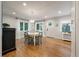 Dining room with hardwood floors, windows, and a decorative chandelier at 2115 Wappoo Dr, Charleston, SC 29412